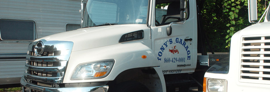 Two tow trucks with Tony's Garage written on the door.