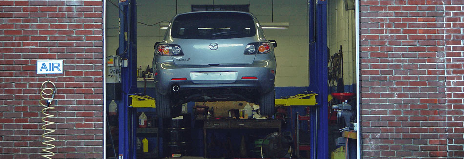 Inside a service bay at Tony's Garage, where an SUV is on a lift getting serviced.